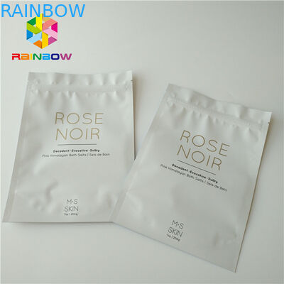 Plásticos brancos estão acima o corpo esfregam o saco de empacotamento cosmético para o sal do mar que banha cuidados com a pele